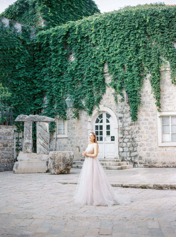 Bride In Wedding Dress Posing Near Old Castle