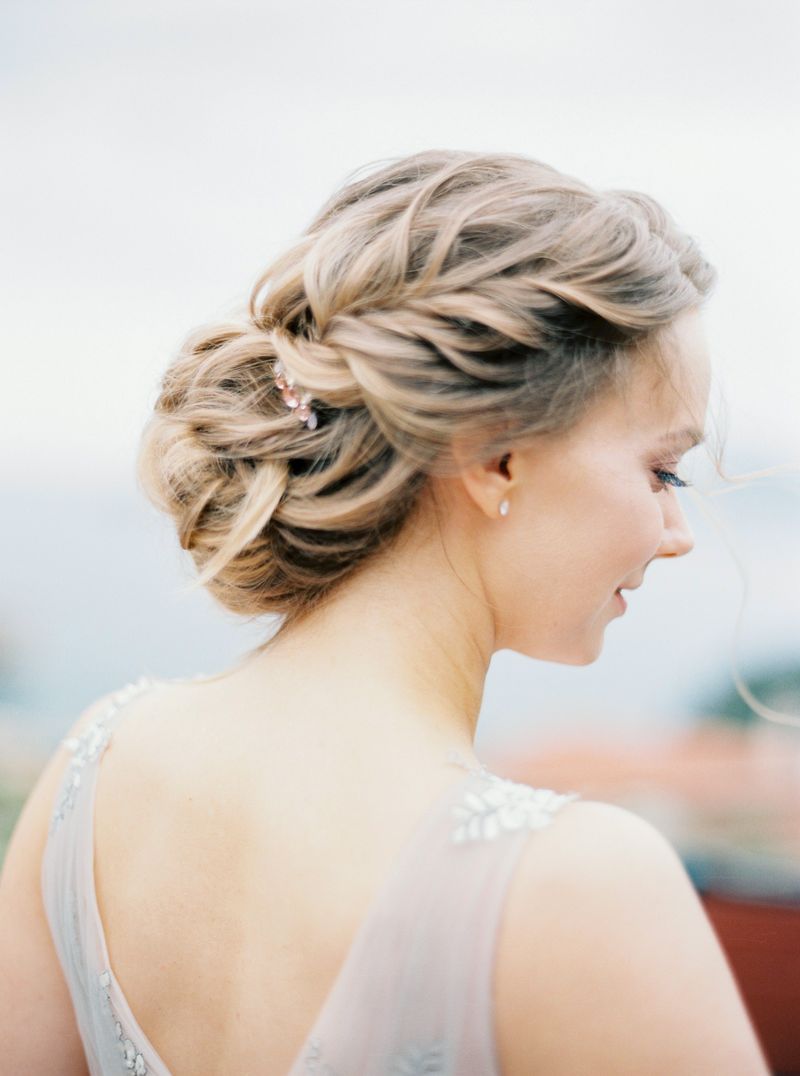 Side profile of a woman with an elegant braided hairstyle