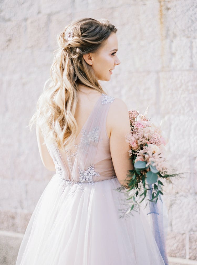 Elegant Bride With Bouquet Posing Outdoors