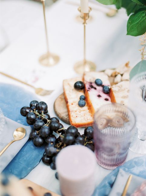 A sophisticated table setting featuring blueberry cake and grapes, perfect for special occasions.