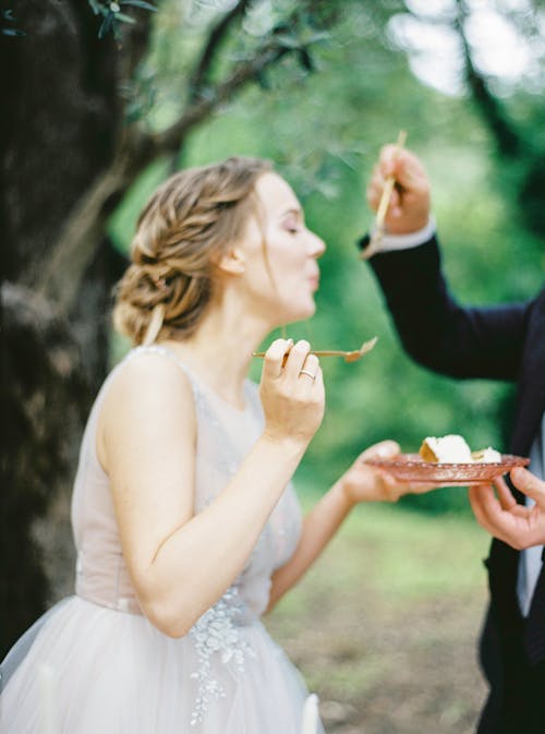 Photo of a Young Bride Eating a Wedding Cake