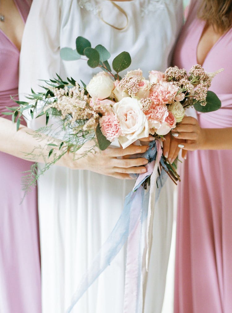 Close-up Of Bride And Bridesmaids Holding Bouquets