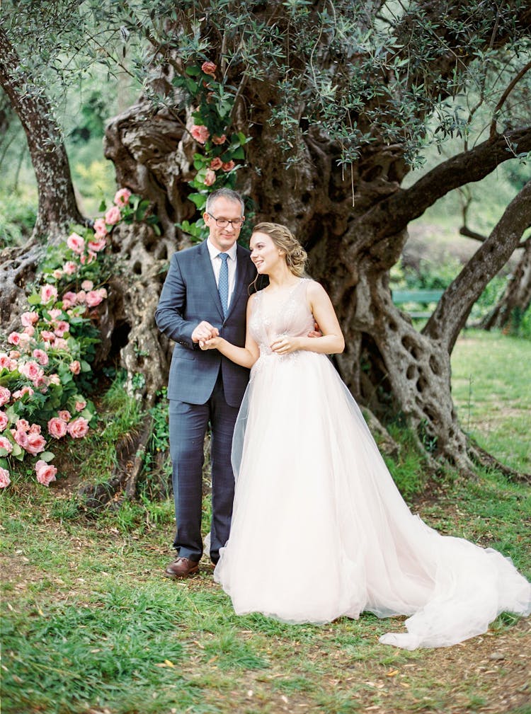 Bride And Groom Posing Near Old Tree