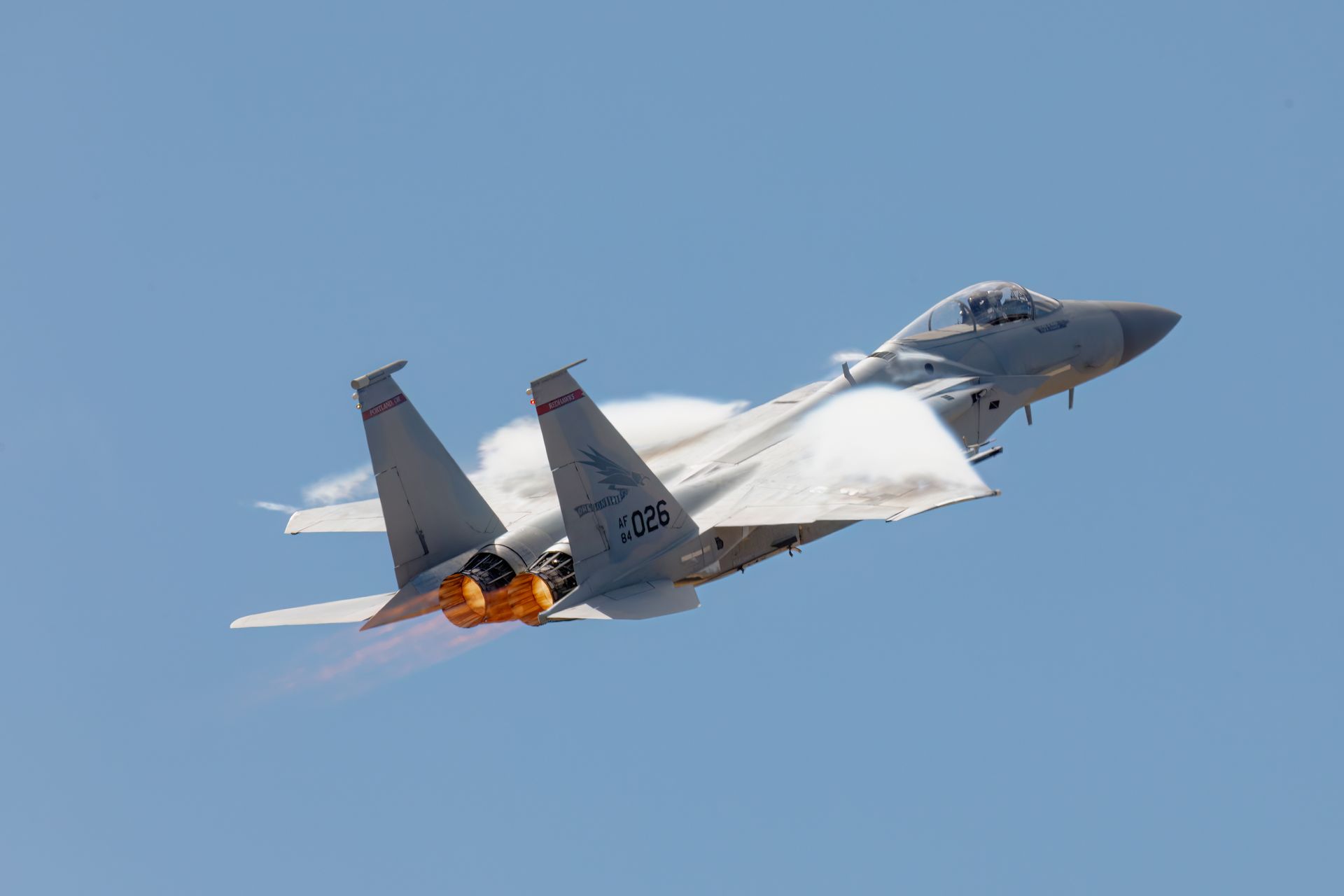 High-speed F-15 jet soaring in clear sky, showcasing its power and agility.