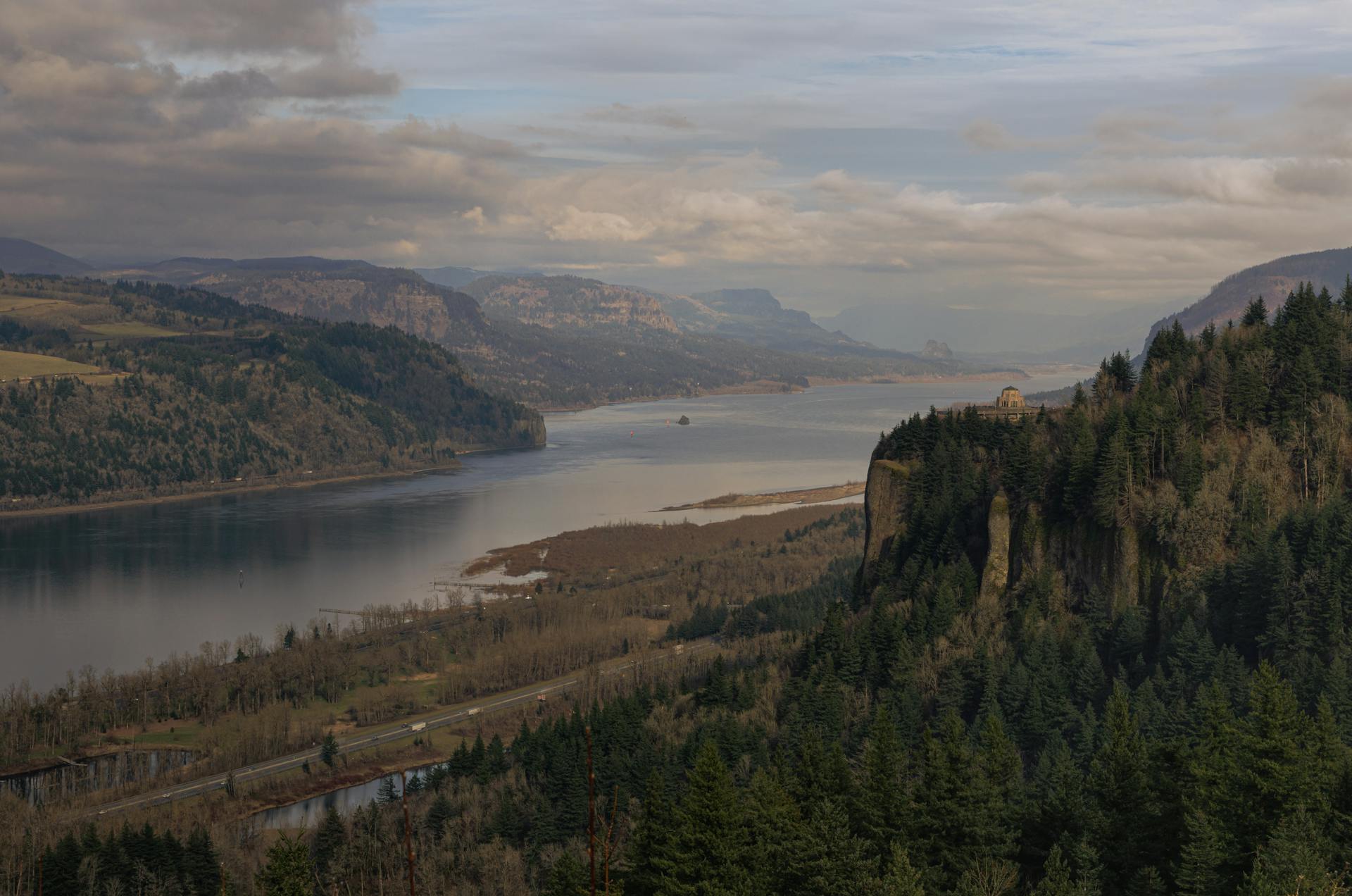 Breathtaking landscape of Columbia River Gorge with misty mountains and lush forests.