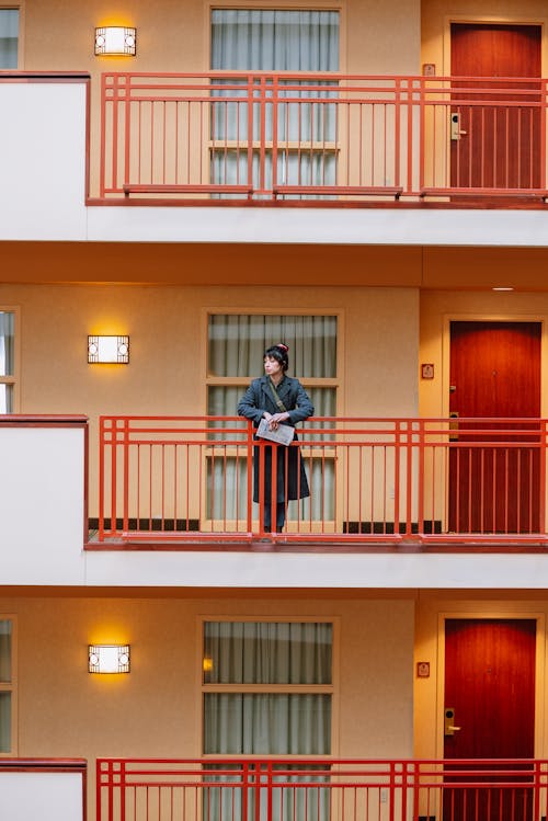 Free Photo of a Woman Standing on a Balcony Stock Photo