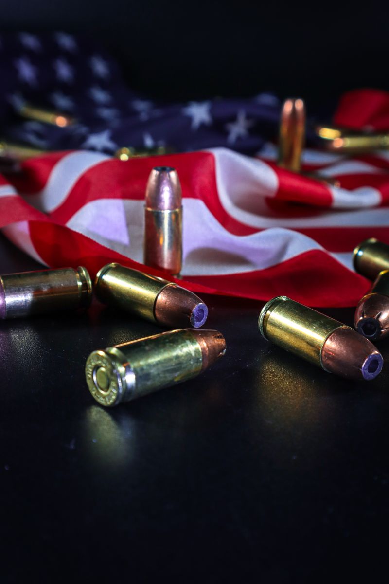 Close-up of ammunition over an American flag, symbolizing patriotism and freedom.