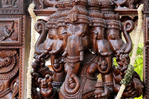 Free Close-up of a detailed wooden Ganesha sculpture reflecting Indian culture and spirituality. Stock Photo