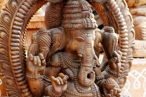 Free Detailed close-up of an intricately carved wooden Ganesha sculpture showcasing Indian artistry. Stock Photo