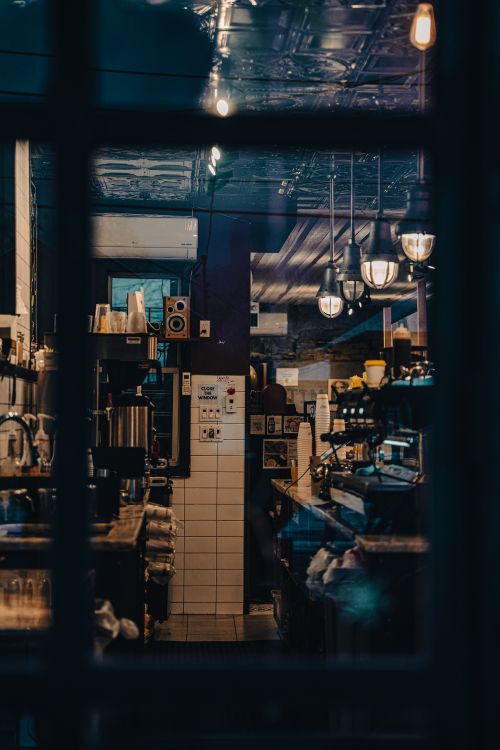 Free A warm and inviting view of a vintage café interior with retro decor and ambient lighting. Stock Photo