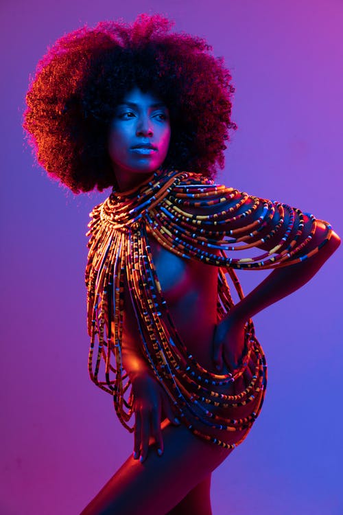A woman with an afro wearing a colorful outfit