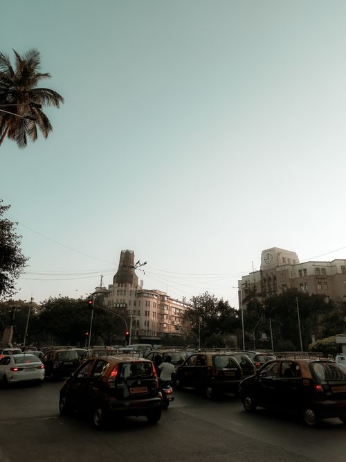 Free City intersection with evening traffic and a clear sky, framed by tall buildings. Stock Photo