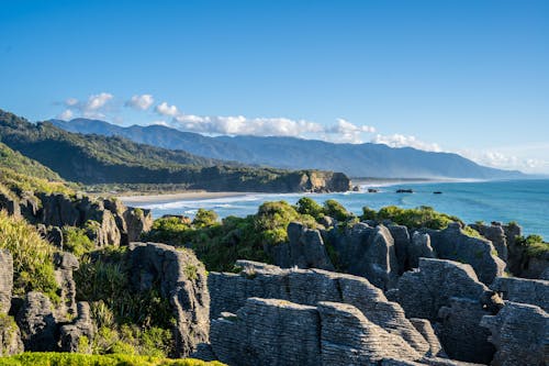 Rocks on Seashore in Mountains Landscape