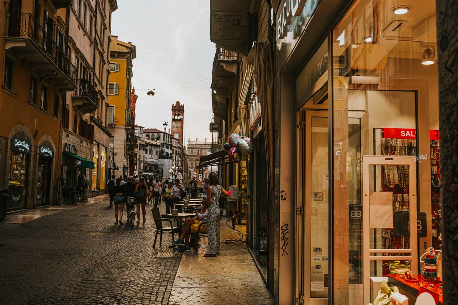 People browsing clothes during the 'Saldi' sales period in an Italian boutique