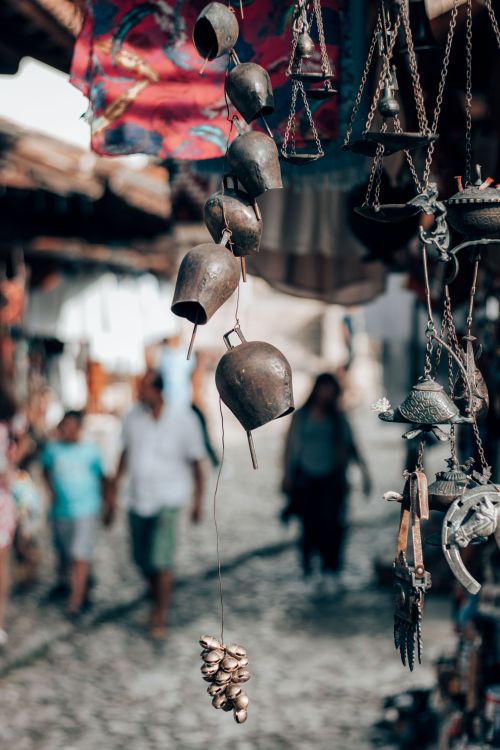 Free Bronze bells and antiques hanging in Kruje's market in Albania, showcasing cultural heritage. Stock Photo