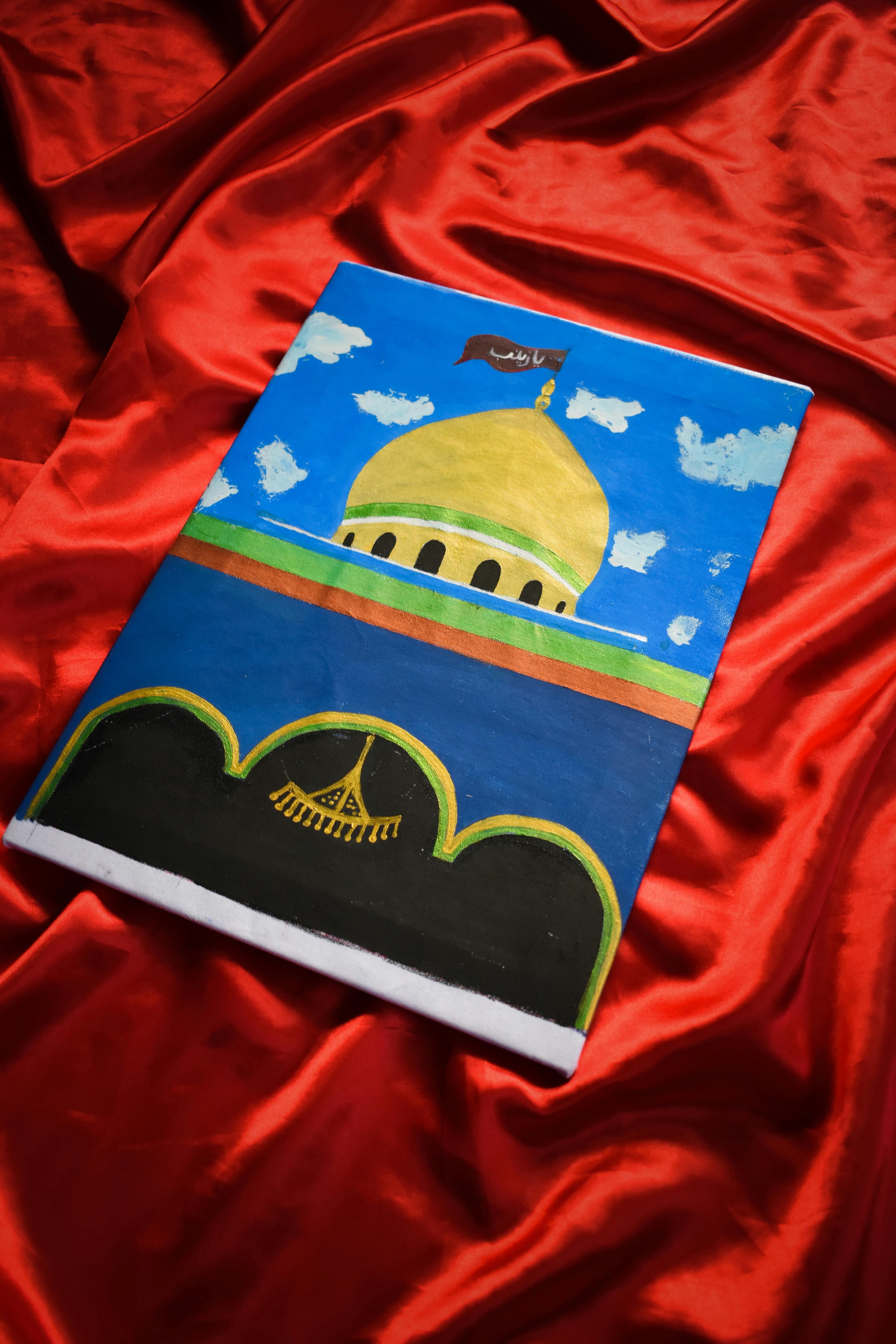 Colorful artistic depiction of a mosque on canvas with a red fabric backdrop, creating a striking contrast.