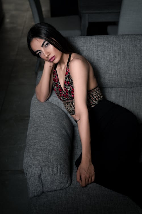 Gorgeous Brunette Woman Posing on Gray Sofa