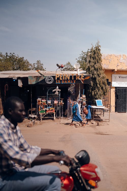 Man Riding a Bike in African Town 