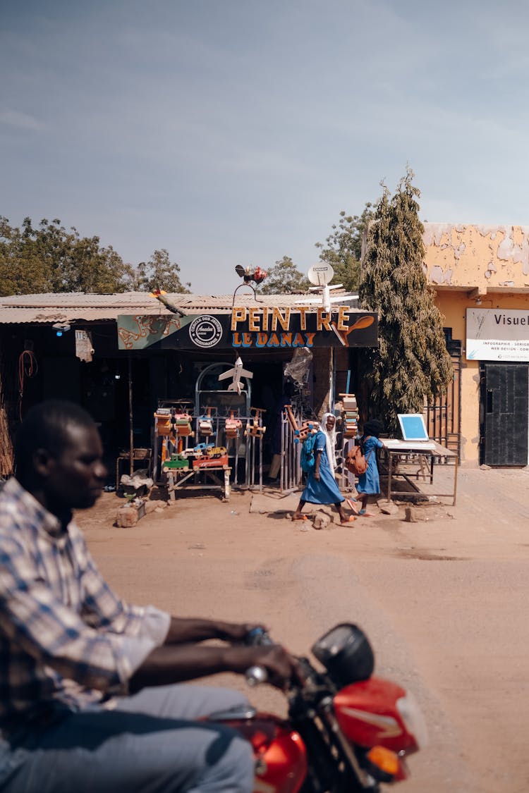 Man Riding A Bike In African Town 