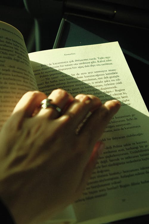 Womans Hand on an Open Book