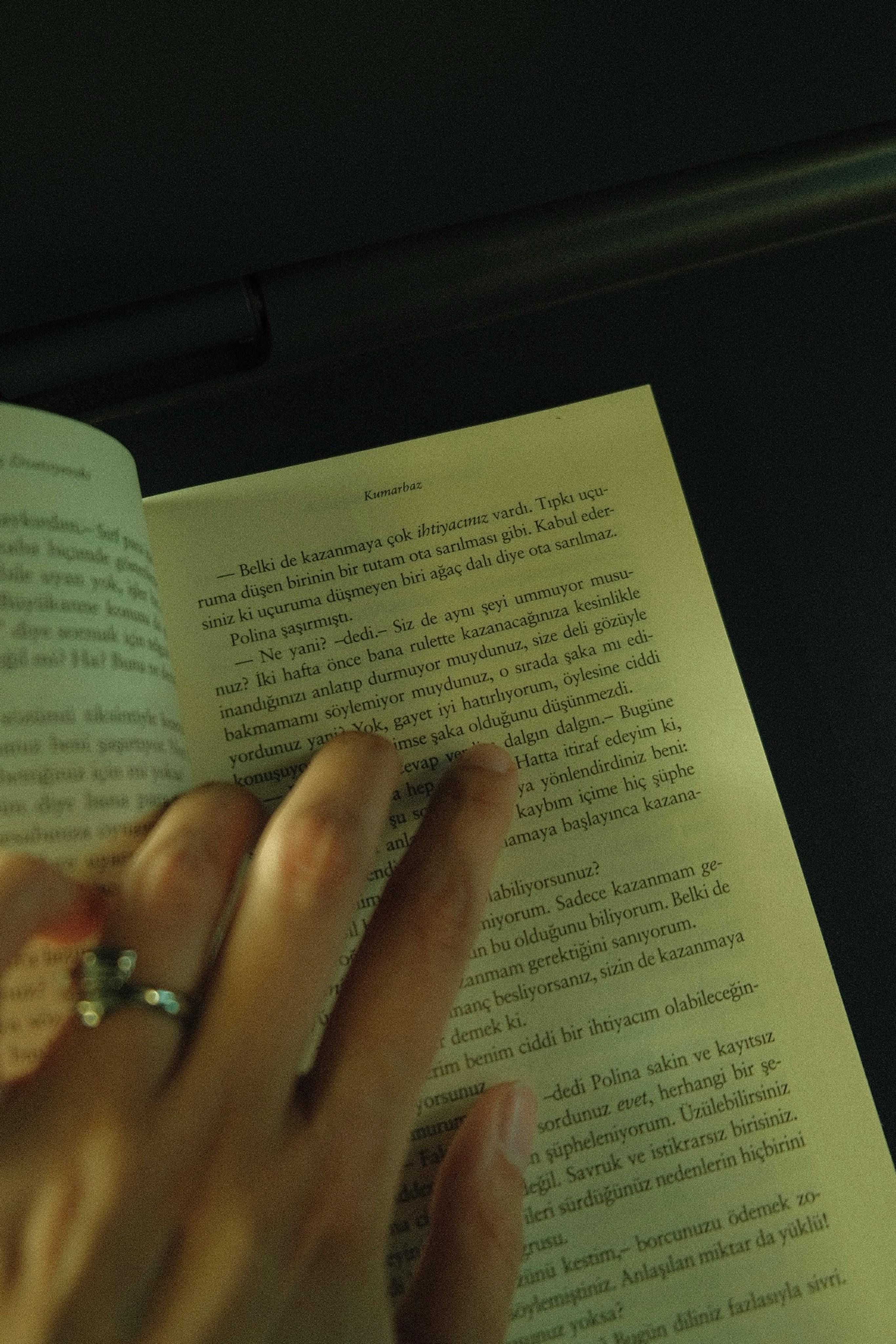 a hand on a book