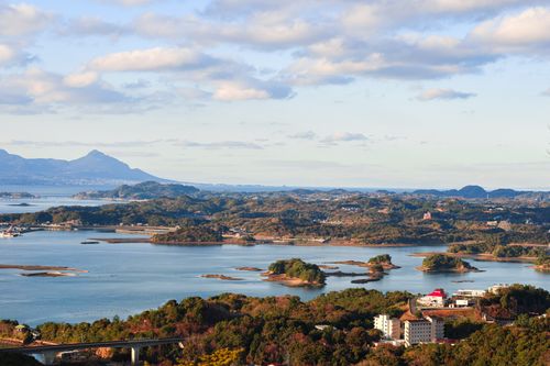 Free A stunning aerial view showcasing Japan's coastal scenery and distant mountains under a bright sky. Stock Photo