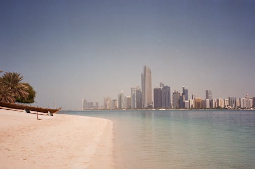 Empty Beach and Sea with Cityscape of Abu Dhabi Skyline in the Distance