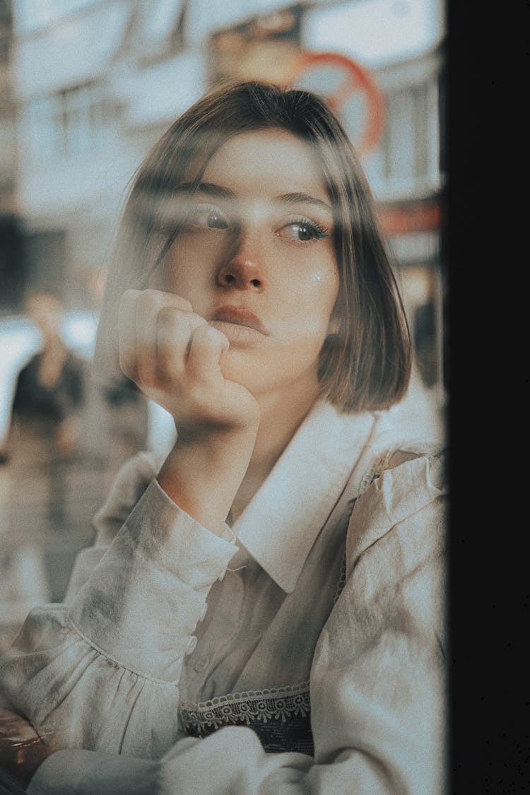 Pensive Woman Looking Through Window