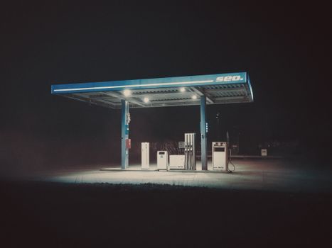 A gas station at night with a sign that says gas