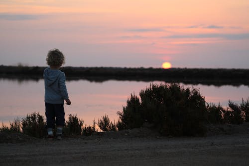 Photo of Toddler Standing Near Lake