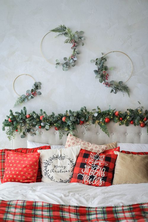 Free Cozy bedroom with Christmas garlands and decorative pillows, perfect for festive inspiration. Stock Photo