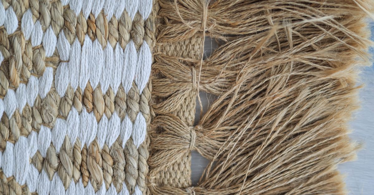 Detailed view of jute and fiber weaving with tassel fringe, showcasing intricate texture.