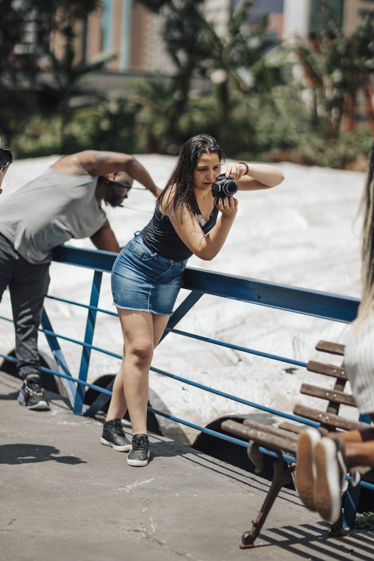 Woman Photographing On A Bridge 