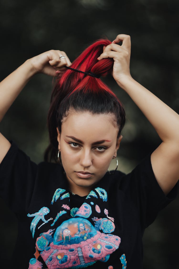 Girl Tying Her Hair In A Ponytail 