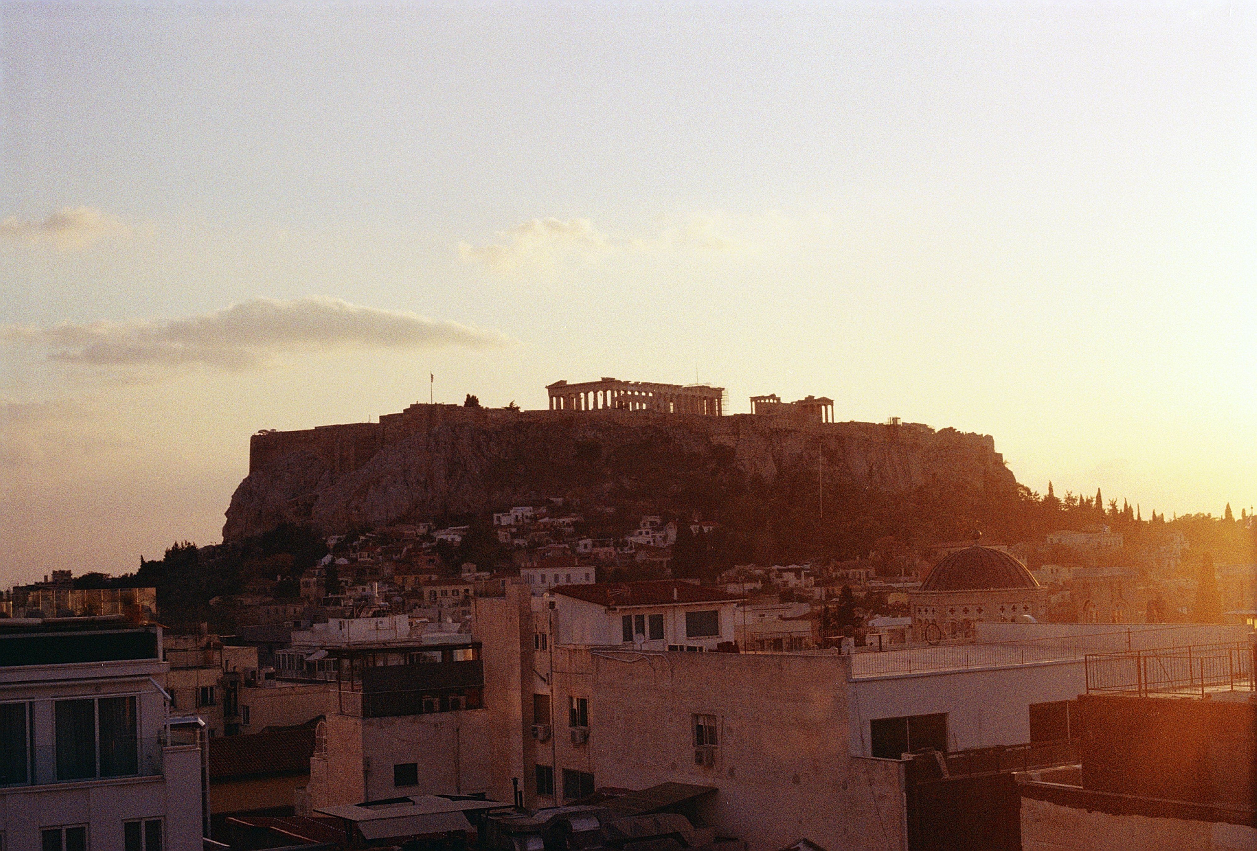 Captivating sunset view of the Acropolis in Athens, Greece, highlighting the ancient architecture. Captivating sunset view of the Acropolis in Athens, Greece, highlighting the ancient architecture.