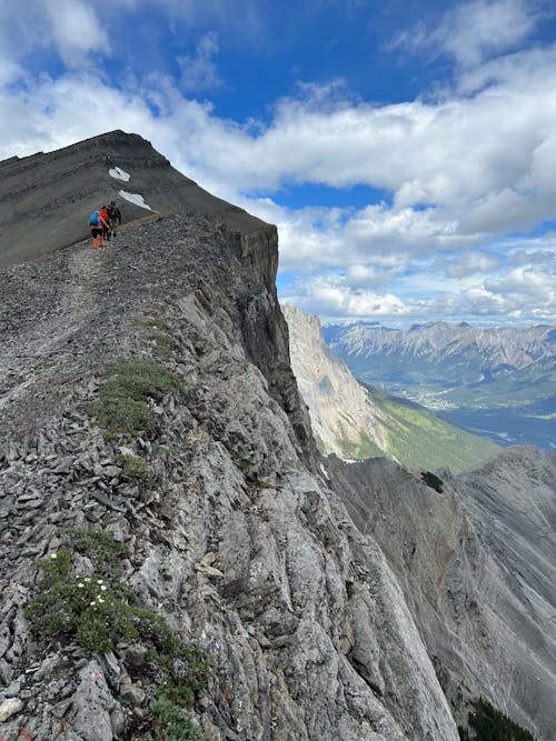 Free Clouds over Mountains with People Hiking Stock Photo