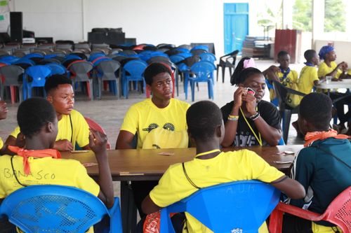 Free A group of teenagers enjoy playing cards indoors, conveying a sense of fun and relaxation. Stock Photo