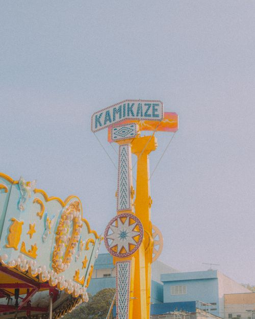 Free Vibrant and nostalgic amusement park ride with Kamikaze sign, perfect for retro-themed designs. Stock Photo