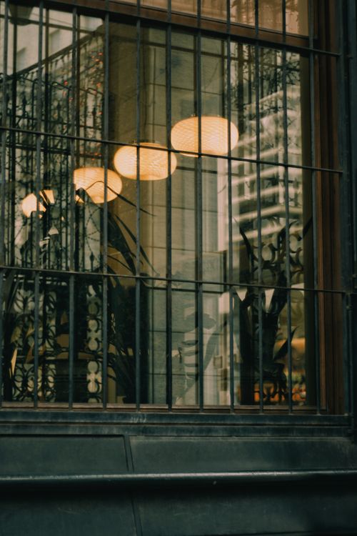Free Artistic view of a window with reflections and warm lighting, creating an urban atmosphere. Stock Photo