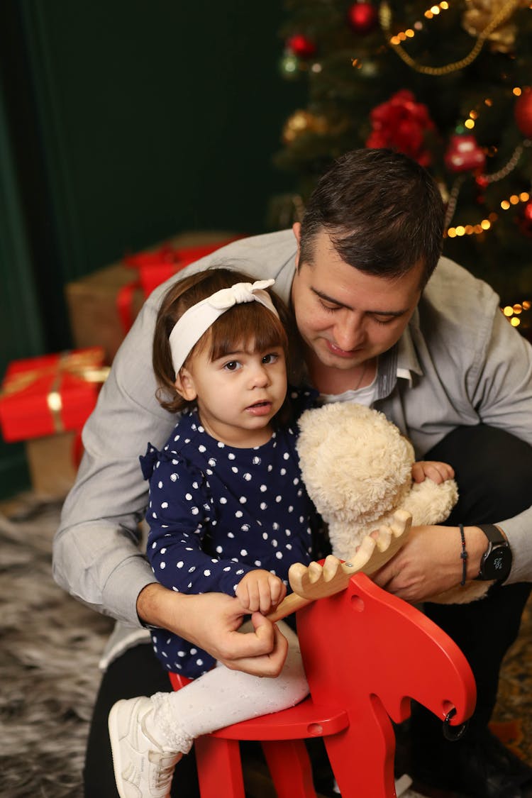 A Dad Giving Christmas Gift To His Daughter