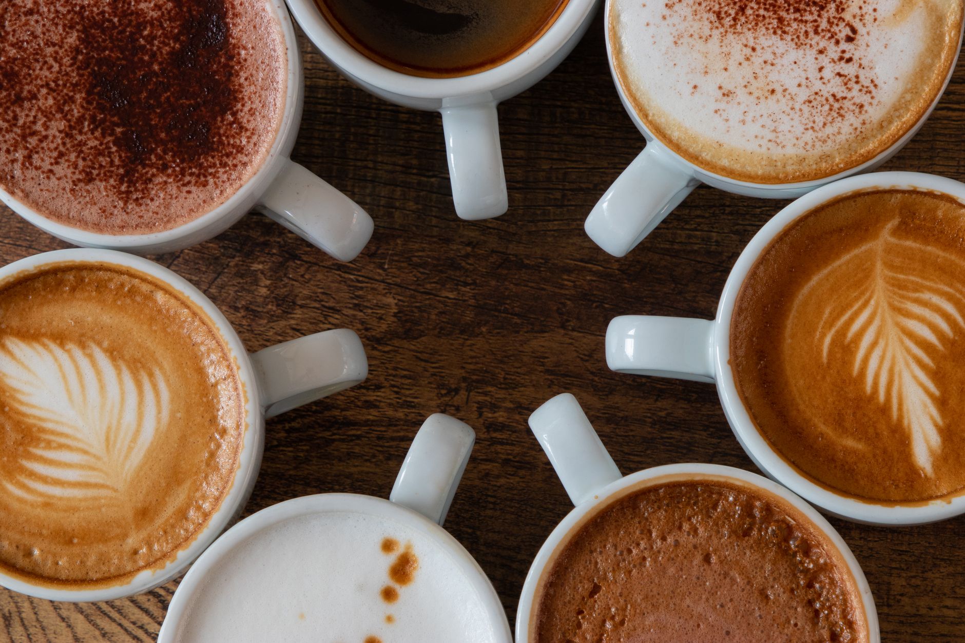 Close up of a macchiato coffee showcasing dark espresso with a light foam mark