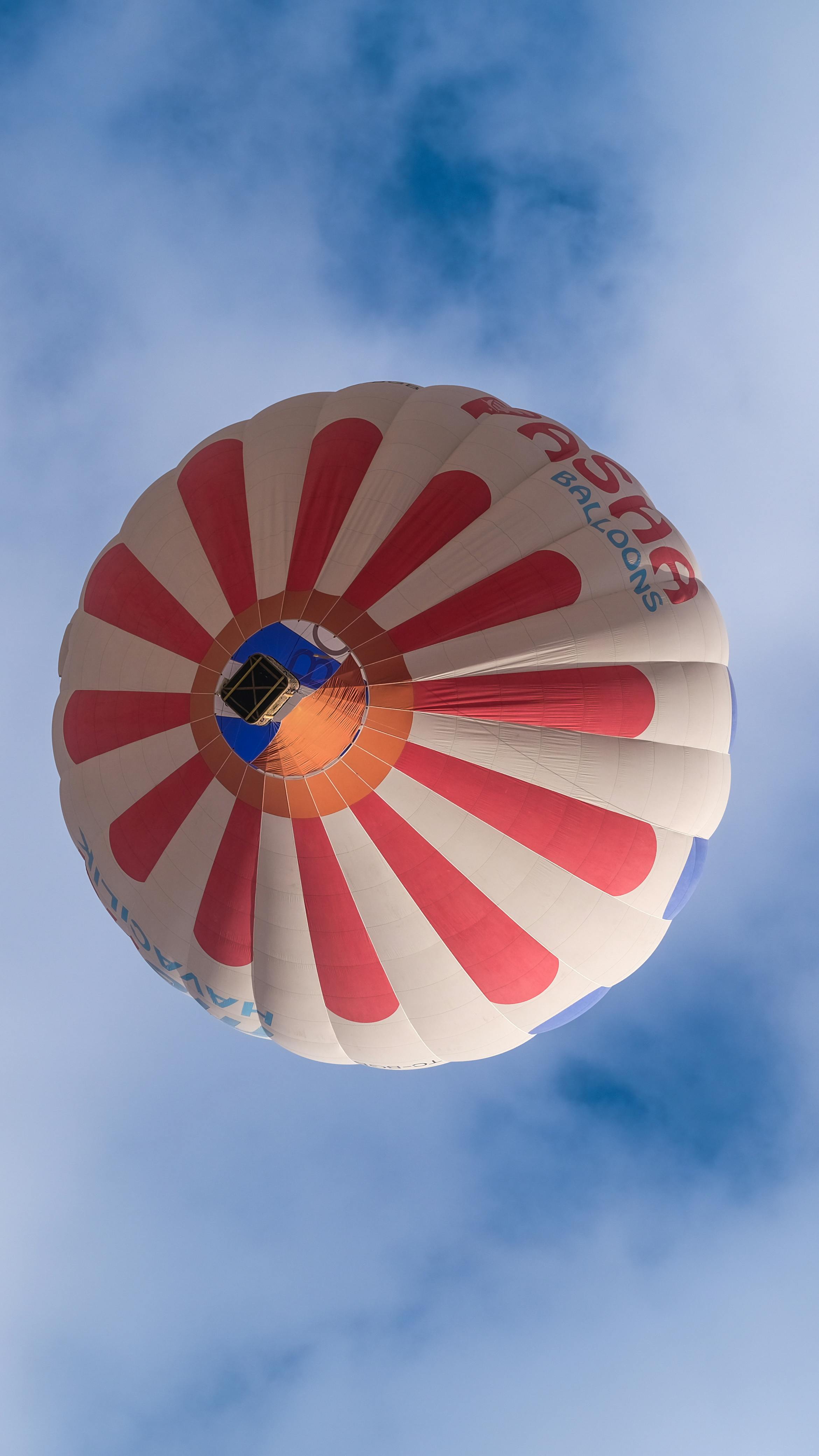 Red and Blue Hot Air Balloon Floating on Air on Body of Water during ...