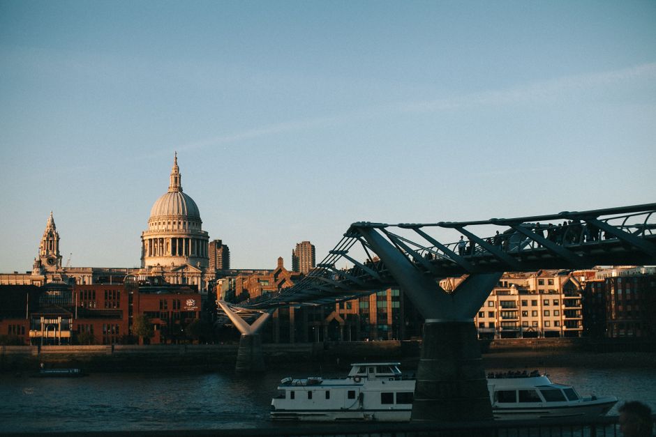 View of Millennium Bridge and St. Paul's from the Thames, capturing the essence of London at dusk.