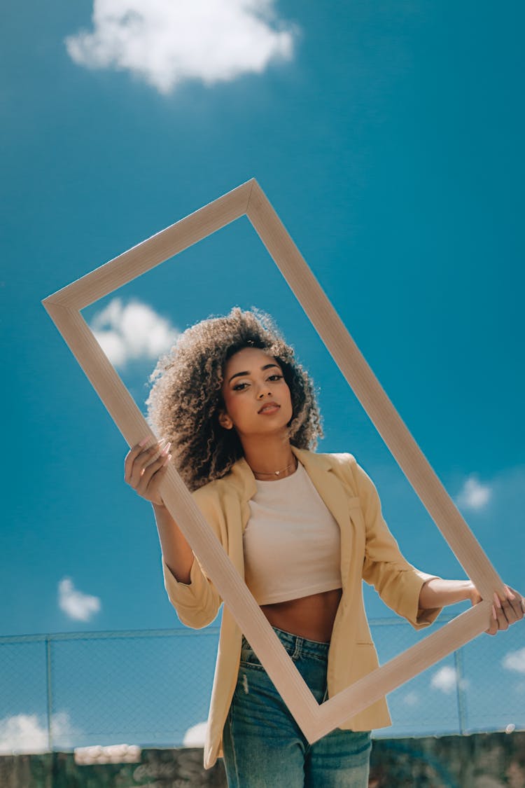 A Woman Holding A Rectangular Frame