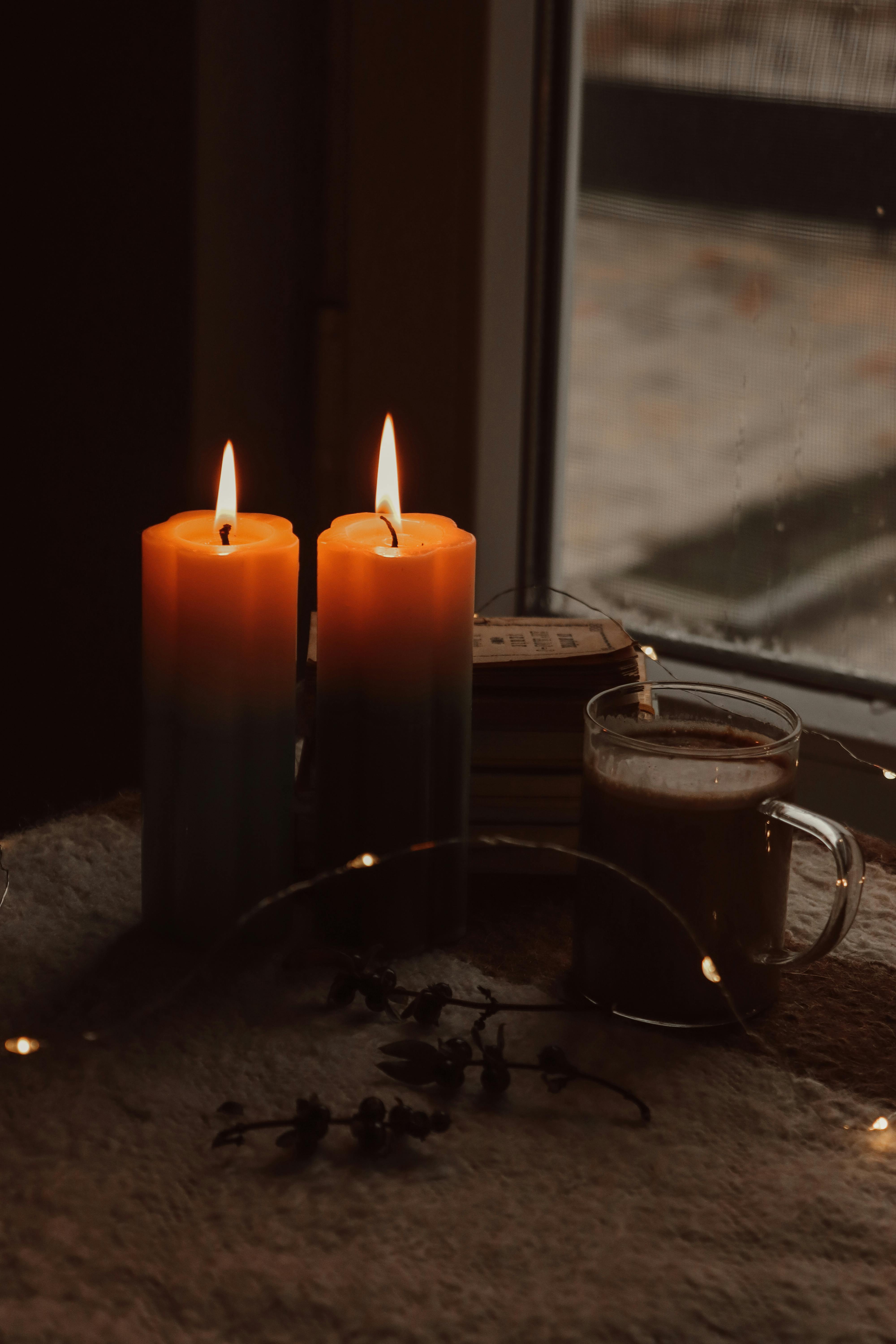 A collection of items that promote relaxation, such as candles, books, and a cup of tea