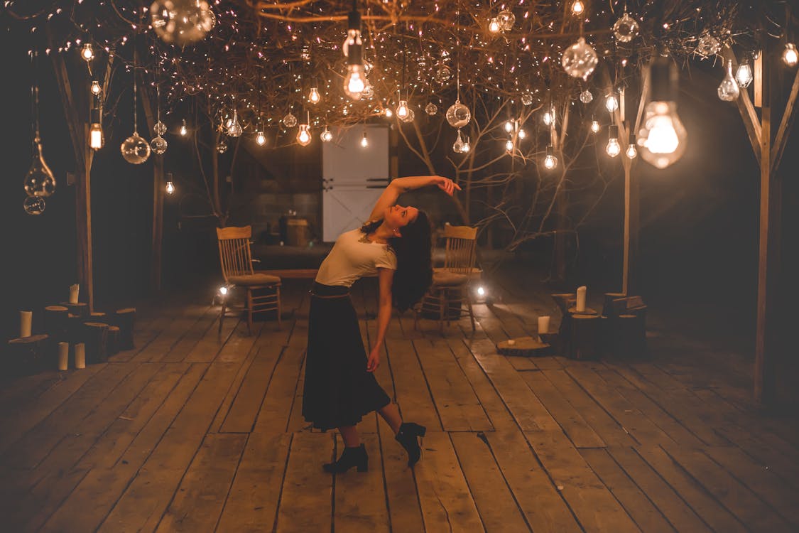 Woman Dancing on Terrace With Lights Turned-on