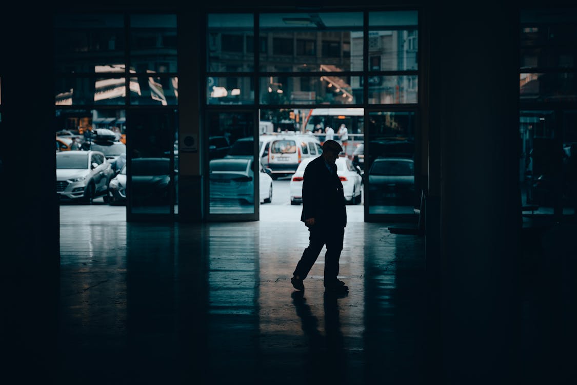 Elderly Man Walking in Hallway