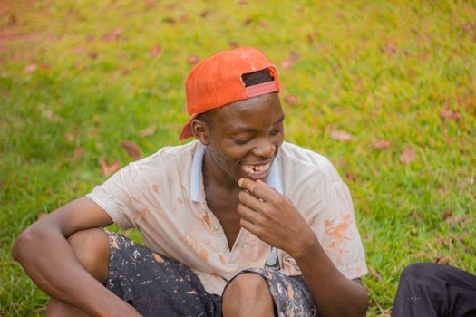 Smiling Boy Sitting on Grass