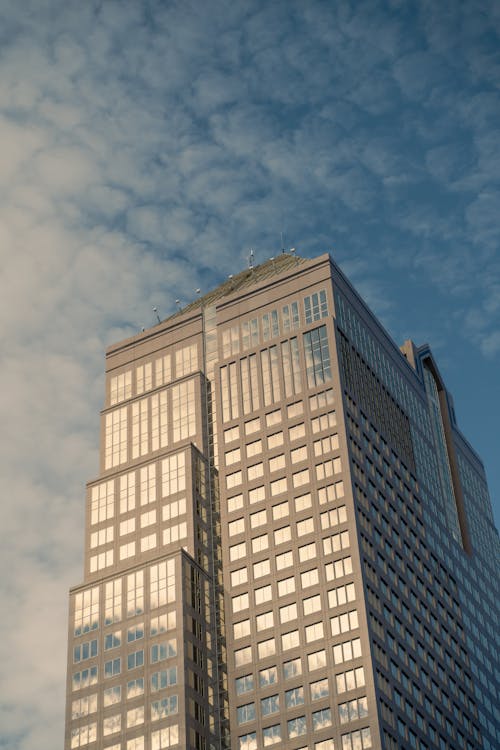 Free Low-Angle Shot of a High Rise Building under the Cloudy Sky Stock Photo