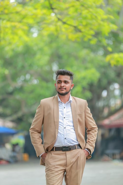 Free A confident man in a beige suit poses outdoors, showcasing fashion and elegance. Stock Photo